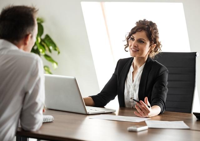 Woman at desk explaining